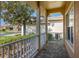 Covered front porch with brick flooring and white railing at 196 Knoll Wood Dr, Kissimmee, FL 34759