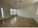 Spacious living room area with tile flooring and large window at 2408 Cedarfield Ln, Kissimmee, FL 34744