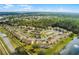 Aerial view of residential community showing its layout, amenities, parking, and proximity to a nearby pond at 2466 Sweetwater Club Cir # 4, Kissimmee, FL 34746