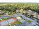 Aerial view showcasing community with tennis court, pool, and parking area surrounded by lush landscaping at 2466 Sweetwater Club Cir # 4, Kissimmee, FL 34746