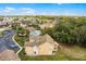 Aerial view of the condo building and surrounding community amenities including the pool and parking area at 2466 Sweetwater Club Cir # 4, Kissimmee, FL 34746