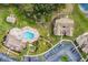 Aerial view featuring a community pool, clubhouse, and well-maintained grounds and ample parking at 2466 Sweetwater Club Cir # 4, Kissimmee, FL 34746