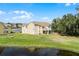 Exterior view of the two-story property and well-maintained lawn, complemented by scenic pond views at 2466 Sweetwater Club Cir # 4, Kissimmee, FL 34746