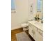 Neutral bathroom showcasing a toilet, sink, and grey rug on ceramic floors at 2641 Calistoga Ave, Kissimmee, FL 34741