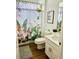 Bathroom featuring a vanity sink, toilet, and framed tropical curtain at 2641 Calistoga Ave, Kissimmee, FL 34741