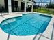 Inviting pool with clear blue water, a spa, and a safety fence, ideal for Gathering enjoyment at 2641 Calistoga Ave, Kissimmee, FL 34741