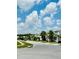 Street view showcases lush lawns, sidewalks, and mature trees lining the street in a well-maintained community at 2641 Calistoga Ave, Kissimmee, FL 34741