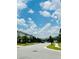 Street view showcases lush lawns, sidewalks, and mature trees lining the street in a well-maintained community at 2641 Calistoga Ave, Kissimmee, FL 34741