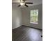 Cozy bedroom featuring new floors, fresh paint and a view of lush green foliage at 3216 Fieldcrest Ter, Deltona, FL 32725