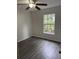 This bedroom has a window with natural light and dark wood-look floors at 3216 Fieldcrest Ter, Deltona, FL 32725