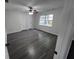 Bedroom featuring modern ceiling fan, neutral colored walls, and gray wood-look flooring at 3216 Fieldcrest Ter, Deltona, FL 32725