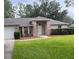Charming single-story brick home with a well-maintained lawn and mature trees at 3216 Fieldcrest Ter, Deltona, FL 32725