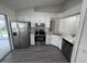 Stylish kitchen features granite countertops, stainless steel appliances, and modern white cabinets at 3216 Fieldcrest Ter, Deltona, FL 32725