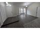 Open living room featuring modern gray wood-look floors, bright natural light, and neutral color palette at 3216 Fieldcrest Ter, Deltona, FL 32725