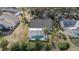 An aerial view of a home featuring a screened-in pool and well-manicured landscaping at 336 California Blvd, Davenport, FL 33897