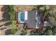 Aerial view of a well-maintained home with dark gray roof and screened in pool at 336 California Blvd, Davenport, FL 33897