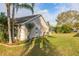 Lush backyard with mature trees, and landscaping surrounding the property at 336 California Blvd, Davenport, FL 33897