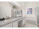 Light and bright bathroom featuring double sinks, soaking tub, and a separate shower stall at 336 California Blvd, Davenport, FL 33897