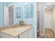 Sky blue bathroom features a single sink vanity and a doorway to the hall at 336 California Blvd, Davenport, FL 33897