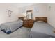 Serene bedroom featuring twin beds, wooden dressers, and soft lighting at 336 California Blvd, Davenport, FL 33897