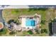 Aerial view of the community pool featuring lounge chairs, tables, and manicured landscaping at 336 California Blvd, Davenport, FL 33897