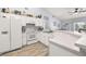 Bright kitchen with white cabinets, appliances, and a breakfast bar at 336 California Blvd, Davenport, FL 33897