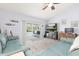 Bright living room with sliding glass doors to the pool, ceiling fan, and neutral wall color at 336 California Blvd, Davenport, FL 33897