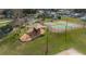 Aerial image of the community playground, tennis courts, and a swimming pool at 336 California Blvd, Davenport, FL 33897