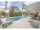 Beautiful screened-in pool area with lounge chairs and outdoor seating at 336 California Blvd, Davenport, FL 33897