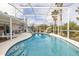 Inviting screened-in pool with lounge chairs, surrounded by lush landscaping at 336 California Blvd, Davenport, FL 33897