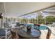 Relaxing screened-in pool area featuring a table for outdoor dining and comfortable seating for poolside enjoyment at 336 California Blvd, Davenport, FL 33897