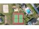 Aerial image highlighting community amenities including tennis courts, playground, and pool at 336 California Blvd, Davenport, FL 33897