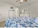 Bedroom featuring a ceiling fan, comfortable bed, and a dresser with mirror at 3930 Palazzo Pl, Winter Haven, FL 33884