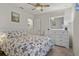 Bedroom featuring a comfortable bed, white dresser, and a ceiling fan at 3930 Palazzo Pl, Winter Haven, FL 33884