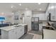 Bright kitchen featuring white cabinets, a large island, and modern appliances at 3930 Palazzo Pl, Winter Haven, FL 33884