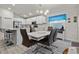 Modern kitchen featuring white cabinetry and stainless steel appliances, next to the dining area at 3930 Palazzo Pl, Winter Haven, FL 33884