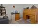 Office featuring a wooden roll top desk, storage cabinets, and a neutral color palette at 3930 Palazzo Pl, Winter Haven, FL 33884