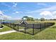 Community playground featuring slides, swings, and a lake view at 3930 Palazzo Pl, Winter Haven, FL 33884