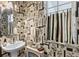 Unique powder room features a pedestal sink and patterned wallpaper at 4086 Kingsley St, Clermont, FL 34711