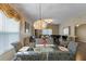 Elegant dining room with large chandelier, dark wood floors, and a view into the living room at 4086 Kingsley St, Clermont, FL 34711