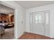 Bright foyer with tile floor and decorative front door, leading into bedroom at 4086 Kingsley St, Clermont, FL 34711