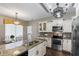 Well-equipped kitchen featuring a granite island, stainless steel appliances, and stylish lighting at 4086 Kingsley St, Clermont, FL 34711