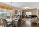 Open living room featuring a glass table, dark wood floors, and natural light at 4086 Kingsley St, Clermont, FL 34711