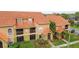 Aerial view of condos showing red tile roofs and landscaping at 425 Fountainhead Cir # 107, Kissimmee, FL 34741