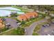 Aerial view of condo complex with parking, landscaping and water feature at 425 Fountainhead Cir # 107, Kissimmee, FL 34741