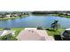 Aerial view of home showing the roof and backyard lake view at 446 Davinci Pass, Poinciana, FL 34759