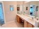 Bathroom features double sinks, vanity, large mirror, and tile floors at 446 Davinci Pass, Poinciana, FL 34759