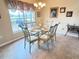 Formal dining room features a glass table, six chairs, and a window view to the outside at 446 Davinci Pass, Poinciana, FL 34759