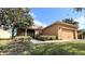 Inviting exterior view of a single-story home featuring a well-manicured lawn and an attached two-car garage at 446 Davinci Pass, Poinciana, FL 34759