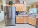 Kitchen featuring stainless appliances, lots of cabinet space, and a decorative backsplash at 446 Davinci Pass, Poinciana, FL 34759